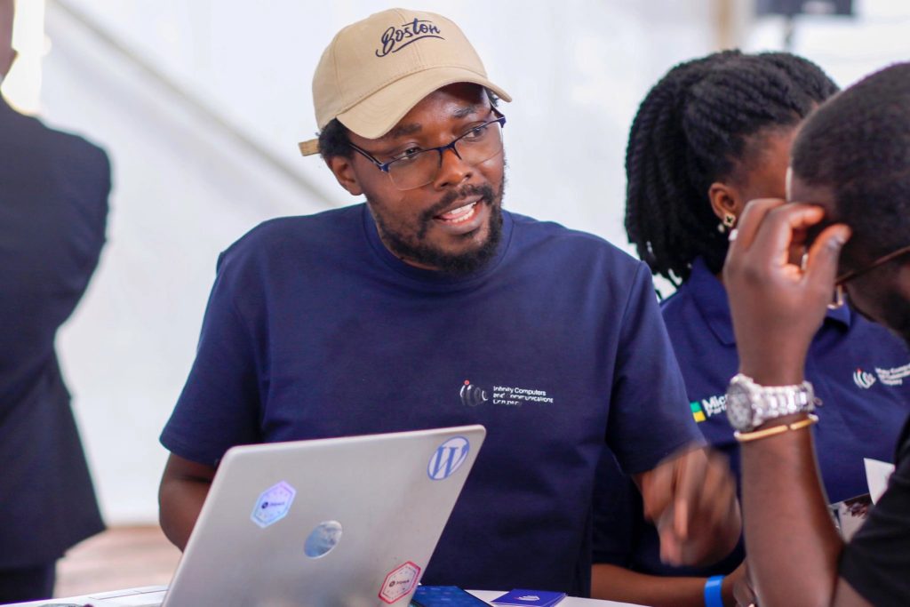 Rashid Migadde talking with visitors at an exhibition stand, Digital Solutions Expo 2026