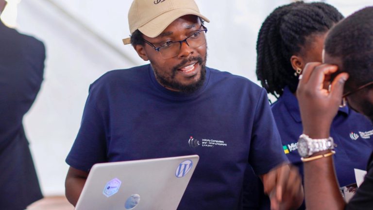 Rashid Migadde talking with visitors at an exhibition stand, Digital Solutions Expo 2026