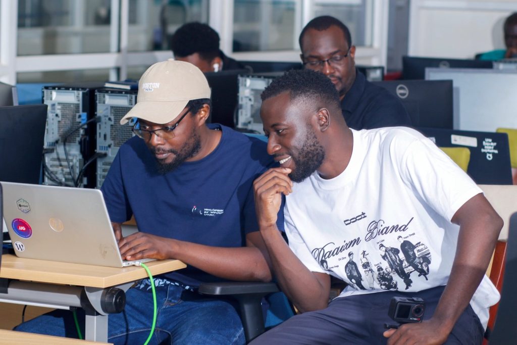 Rashid Migadde working through a hands-on exercise with a participant at the IPv6 certification training