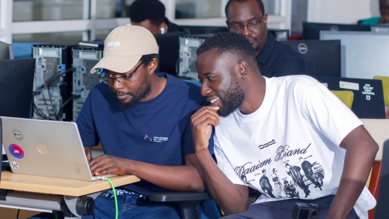 Rashid Migadde working through a hands-on exercise with a participant at the IPv6 certification training