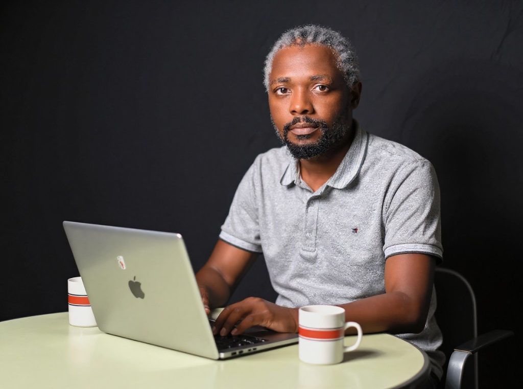 Rashid Migadde at his laptop